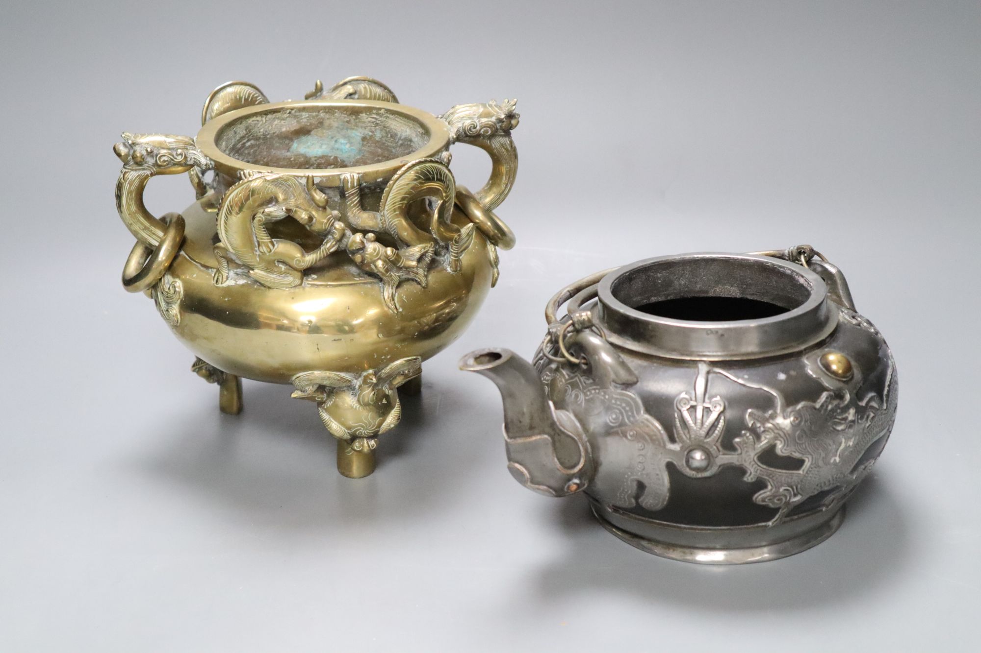 A Chinese bronze tripod censer, height 16cm, and a Chinese pewter-mounted Yixing pottery teapot, lacking lid (2)